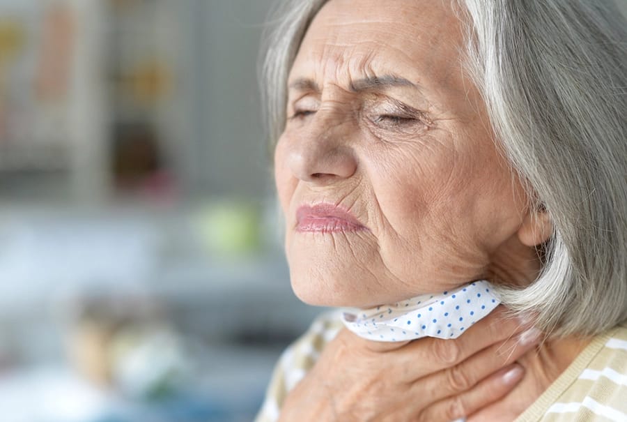 Imagen mujer con molestias en el cuello por infección respiratória para la entrada de abril.