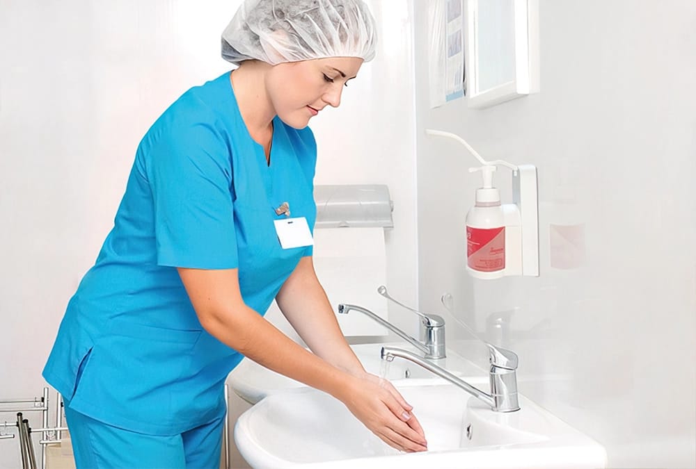 Sanitaria realizando un protocolo de antisepsa de la piel previo al tratamiento de un paciente y7o usuario para la entrada higiene personal en residencias